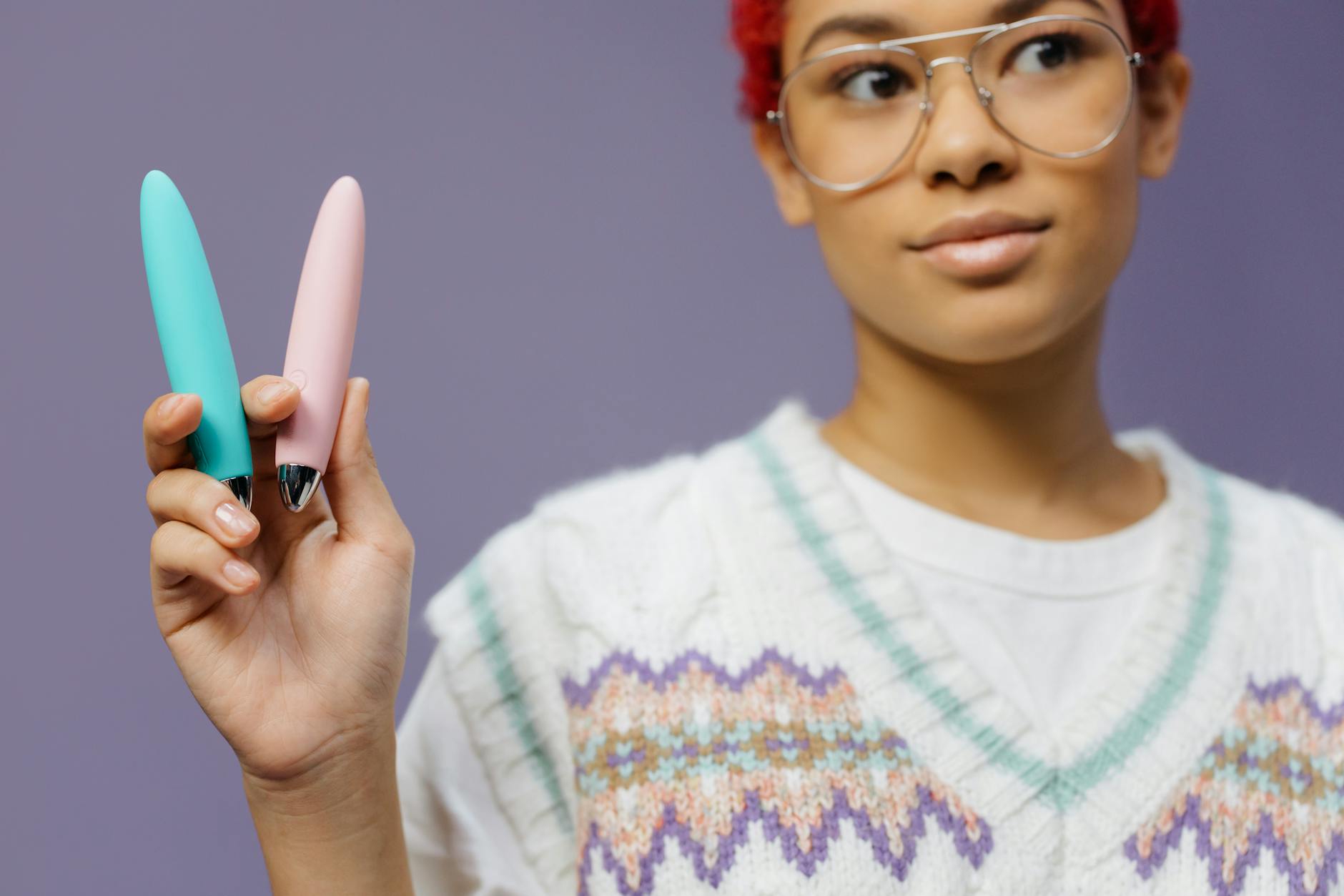 A yellow silicone vibrator surrounded by peeled bananas on a bright yellow background