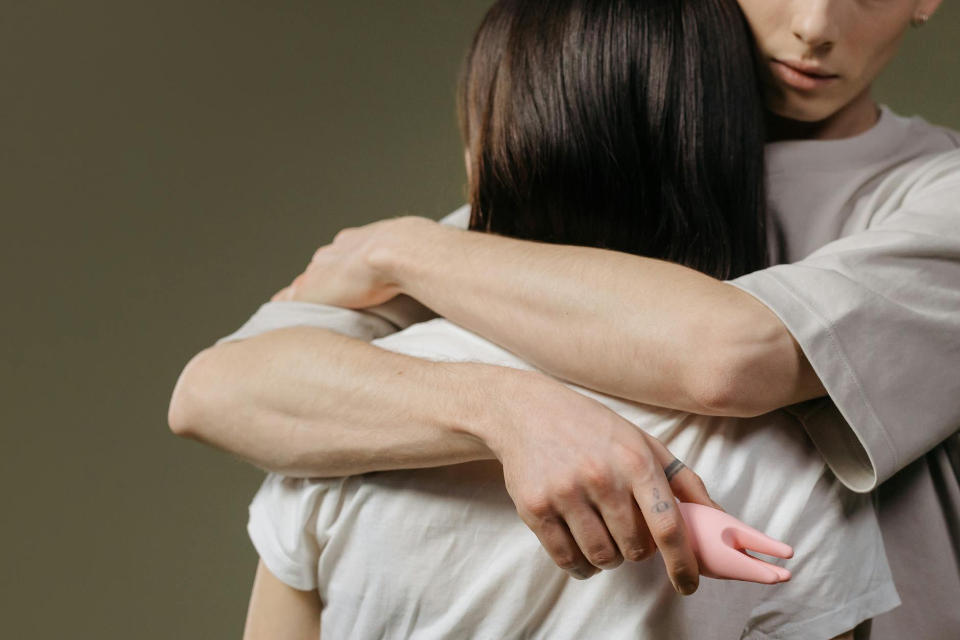 Two people embracing with intimacy and emotional connection in a supportive moment.